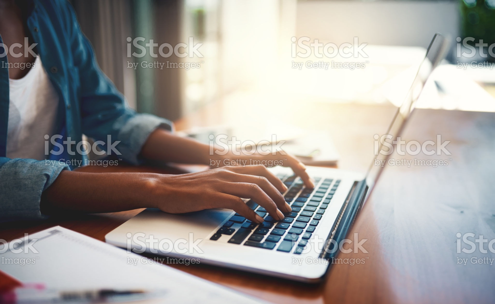 Closeup shot of an unrecognizable woman using a laptop while working from home
